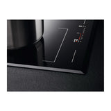 AEG IKE85651 80cm Multibridge Induction Hob from HomeWise Appliances stock photo showing close up of the frameless surround and bevelled corner edge.